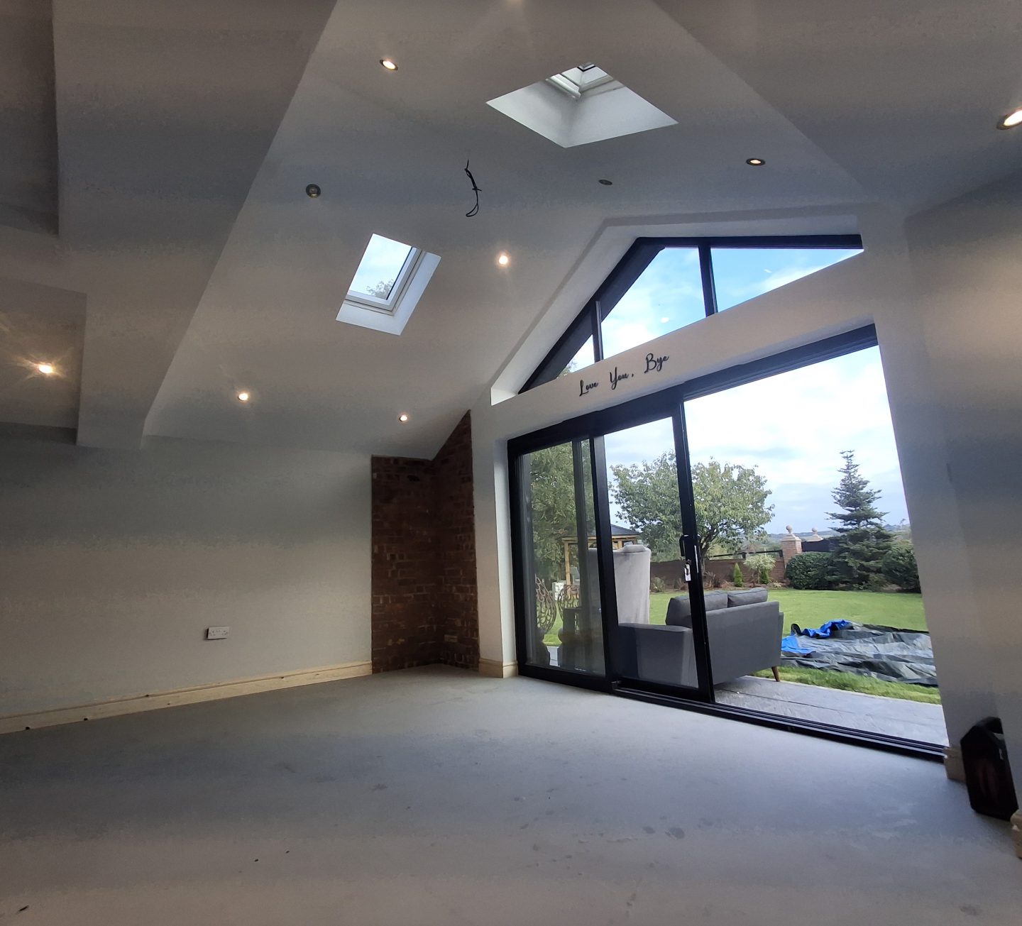 Interior of a Gilbert O'Neill project mid-construction, freshly plastered with new glazing installed